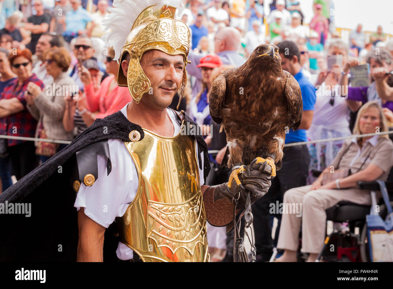 Actor with a live eagle playing the part of a Roman soldier in the Passion play, Adeje, Tenerife, Canary Islands, Spain. Represe Stock Photo