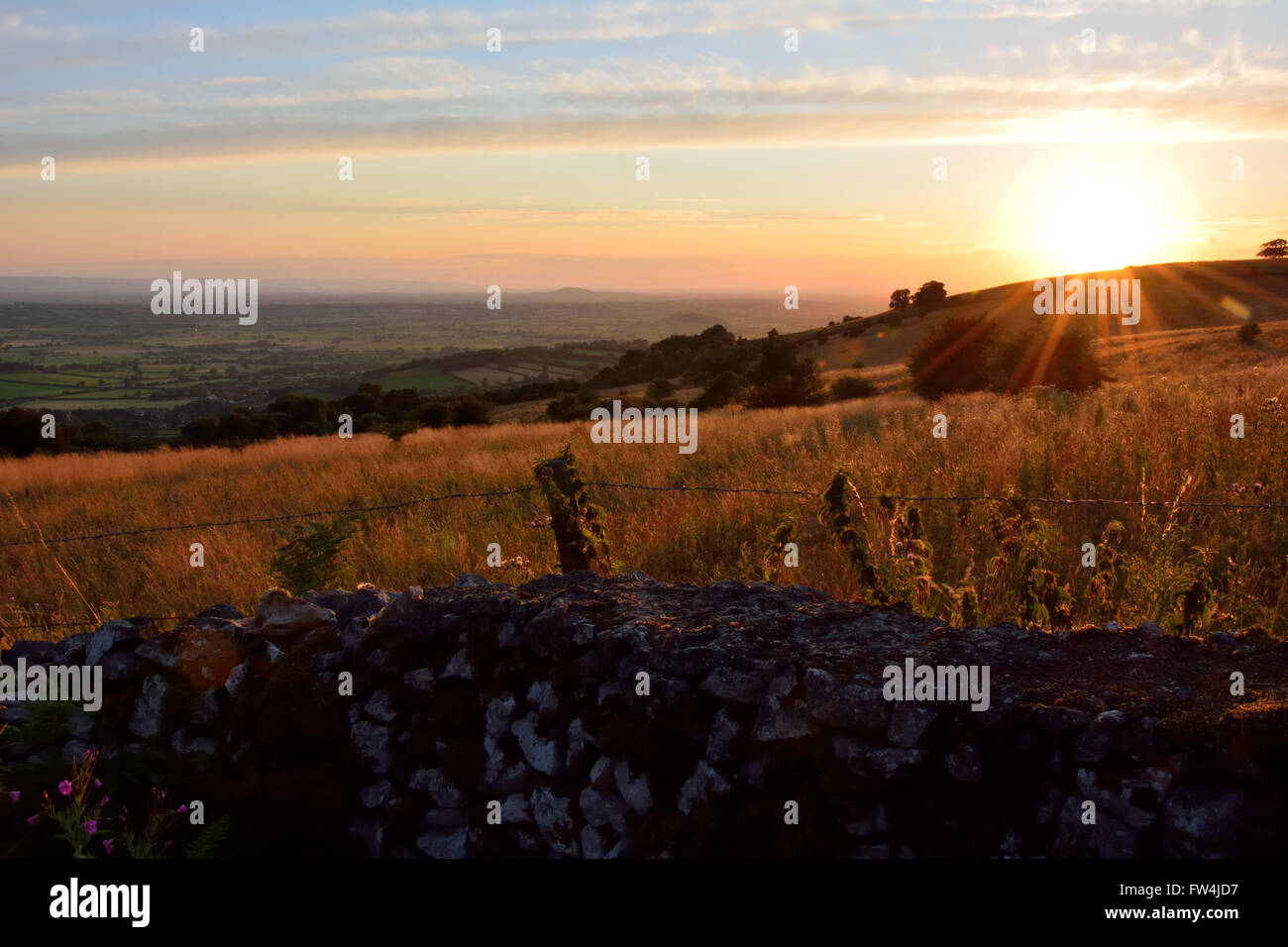 Looking west over the Mendip Hills at sunset. A view over Somerset and the Levels from an Area of Outstanding Natural Beauty Stock Photo