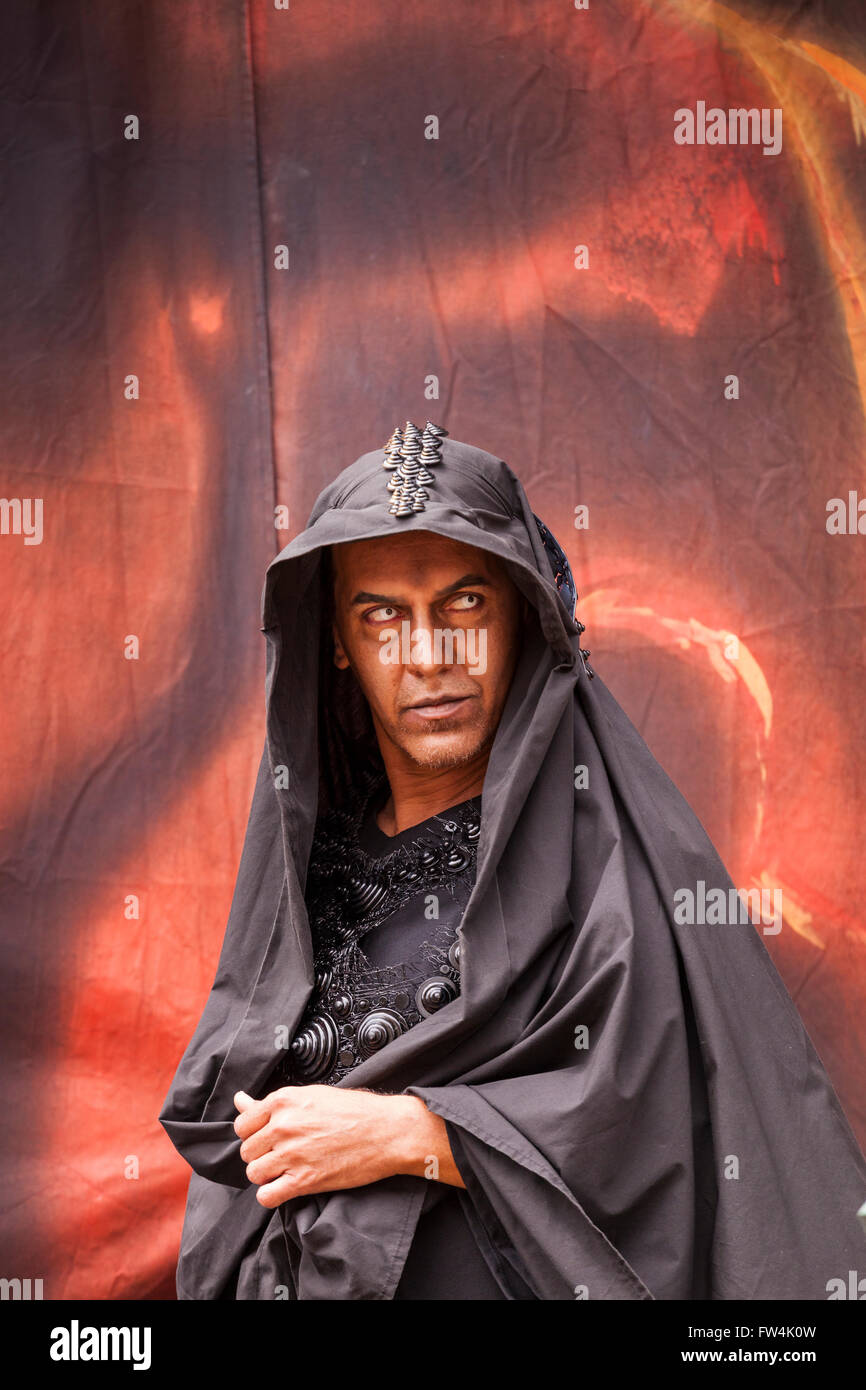 Actor with contact lenses and dark hood playing Satan in the Passion play, Adeje, Tenerife, Canary Islands, Spain. Representacio Stock Photo