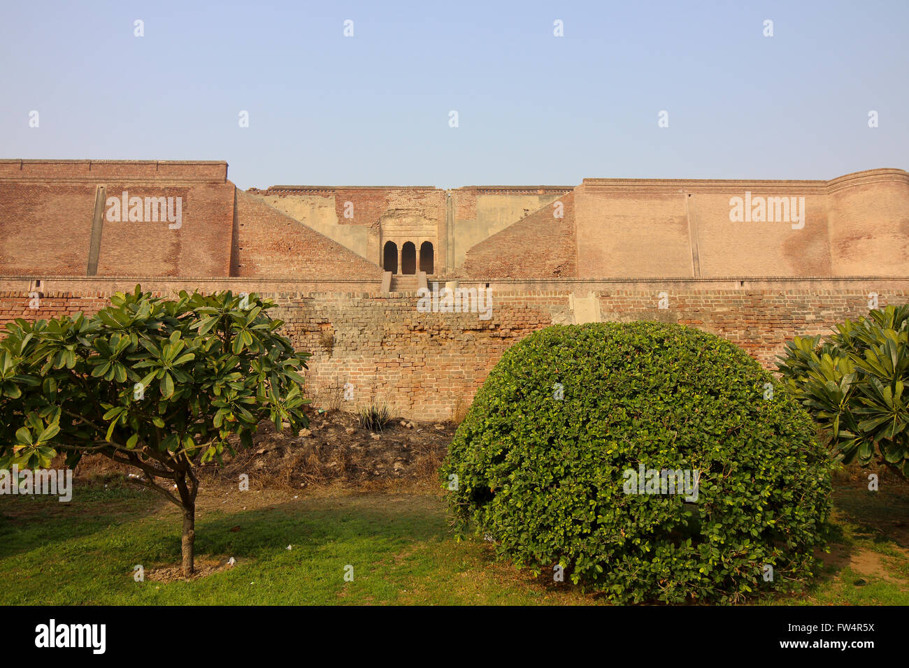 Neatly kept gardens and red brick walls at the restored Bathinda fort in Punjab, India Stock Photo