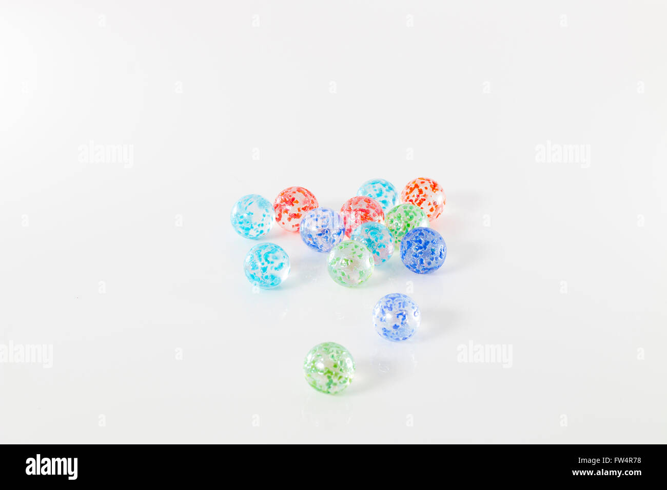 colored marbles, isolated on white studio background Stock Photo - Alamy