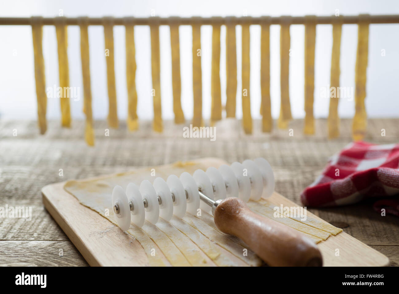 Making homemade tagliatelle pasta cutting and drying the pasta Stock