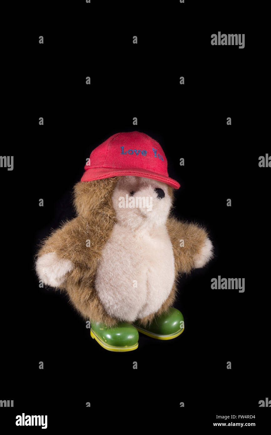 Teddy bear with red cap and green boots Stock Photo
