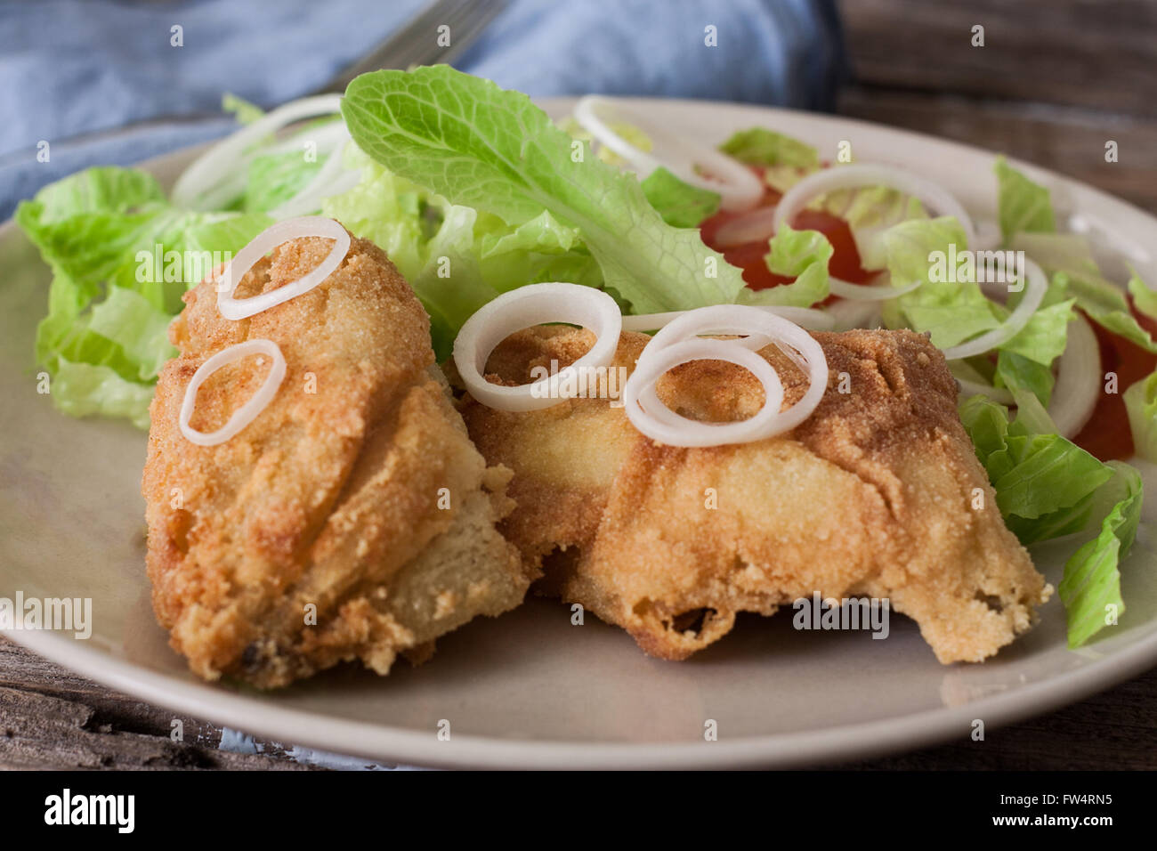 deep fried cod fish with salad on plate Stock Photo Alamy
