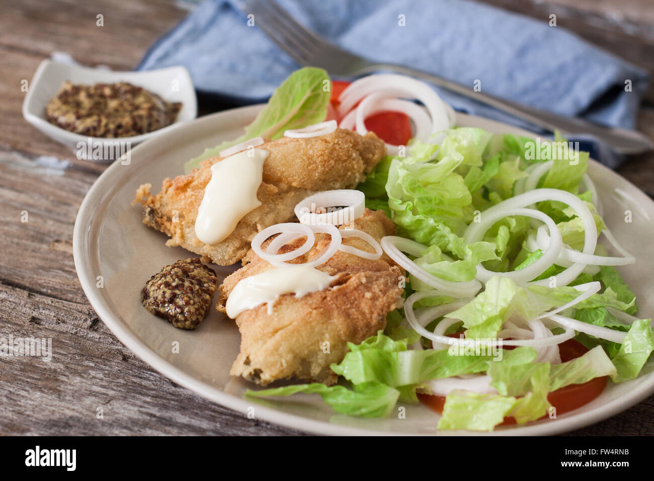 deep fried cod fish with salad mayonnaise and mustard Stock Photo Alamy