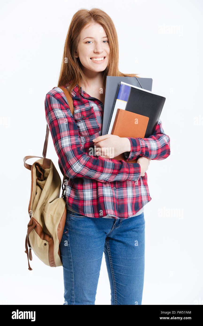Smiling female student standing with book isolated on a white ...
