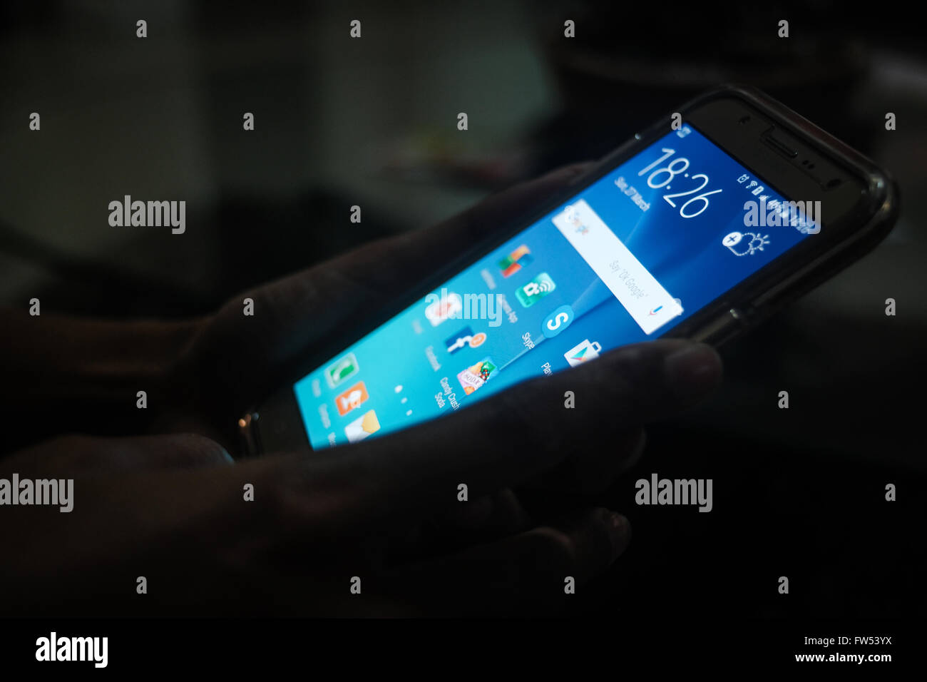 By the light of the phone. Stock Photo
