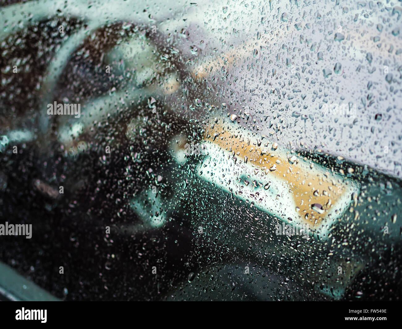 Raindrops on luxury car window, shallow depth of field Stock Photo