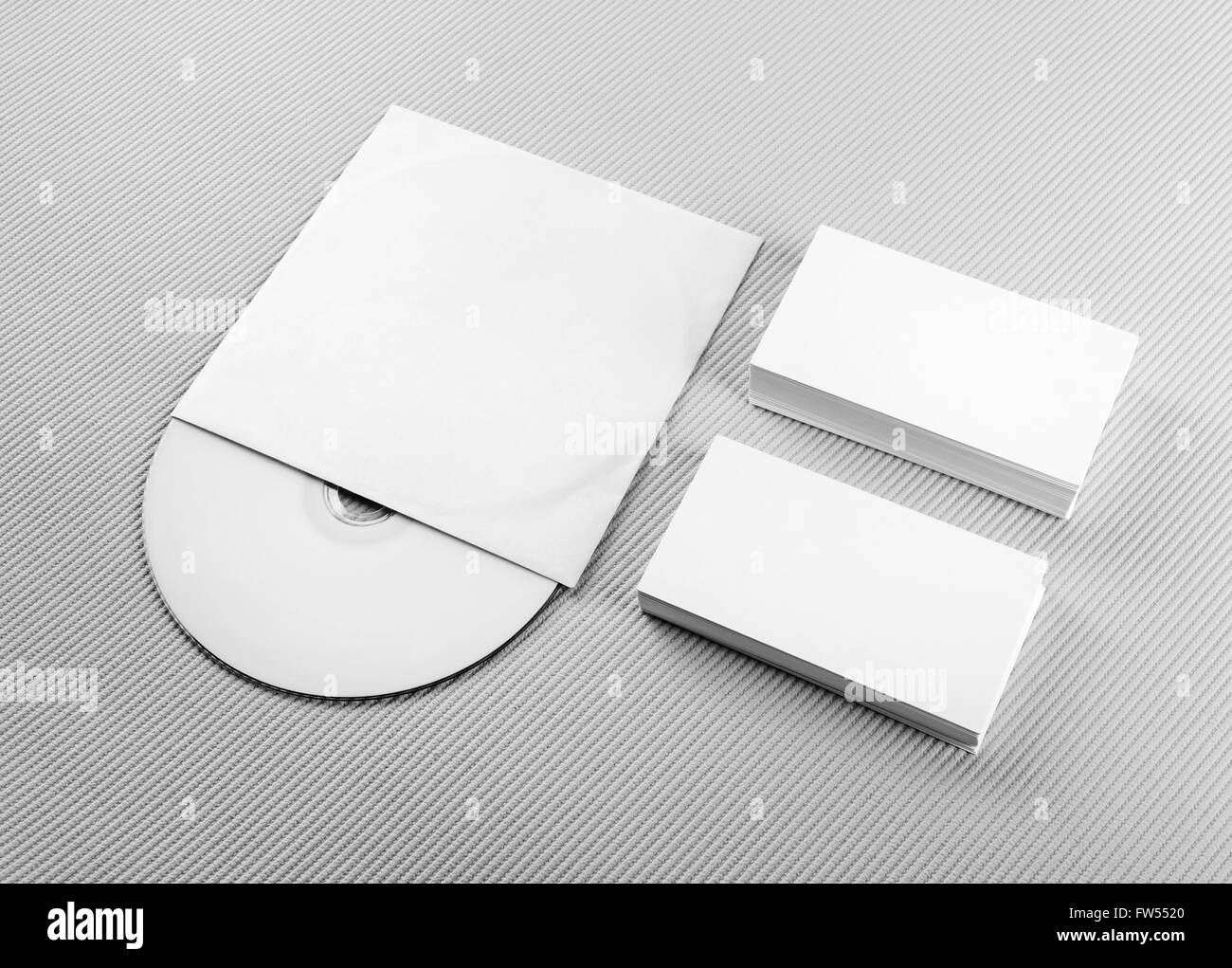 Blank business cards and CD on gray background. For design presentations and portfolios. Mockup for branding identity. Stock Photo