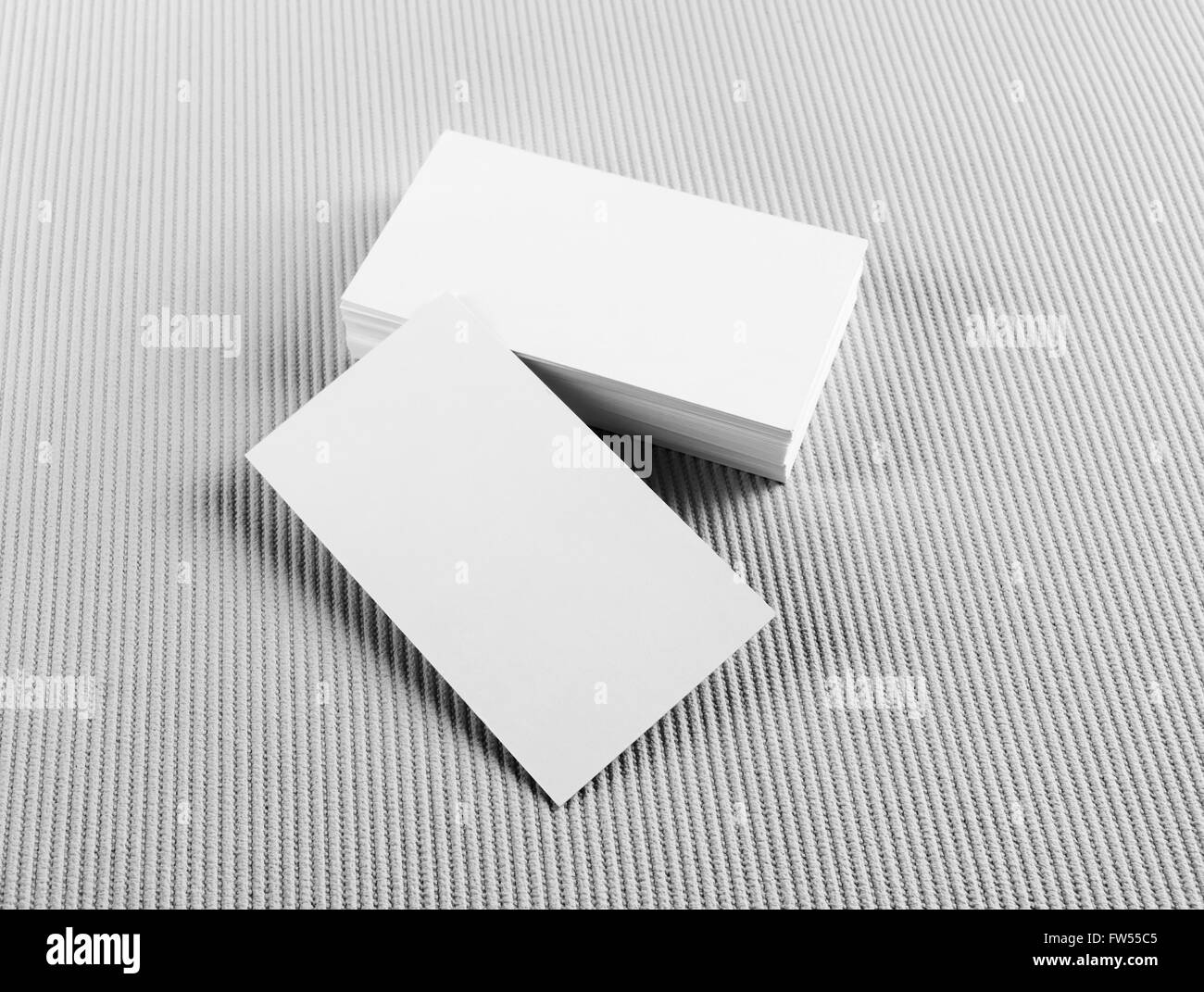 Photo of blank business cards with soft shadows on gray background. Mock-up for branding identity. Stock Photo