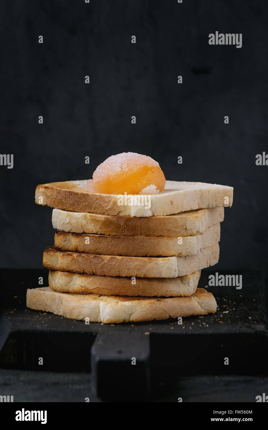 Toasts with yolk over black Stock Photo Alamy