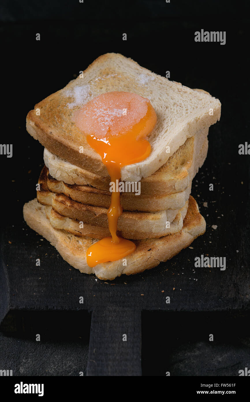 Toasts with yolk over black Stock Photo Alamy
