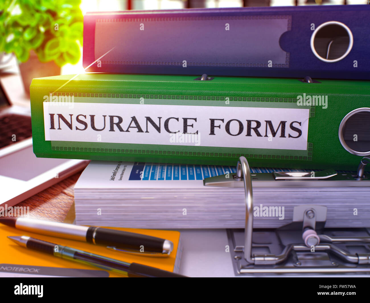 Insurance Forms on Green Ring Binder. Blurred, Toned Image Stock Photo