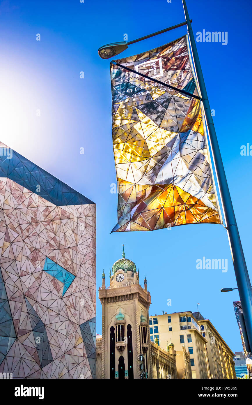 Colourful flag depicting triangular design of Federation Square looking across to the Forum Theatre, city of Melbourne Australia Stock Photo