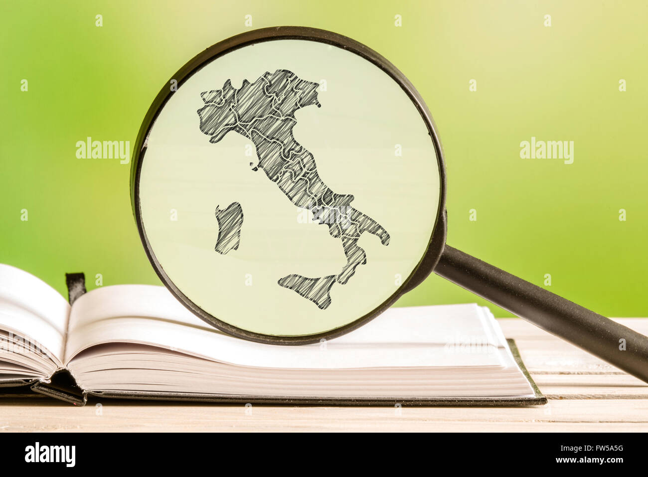 Italy with a pencil drawing of a italian map in a magnifying glass Stock Photo