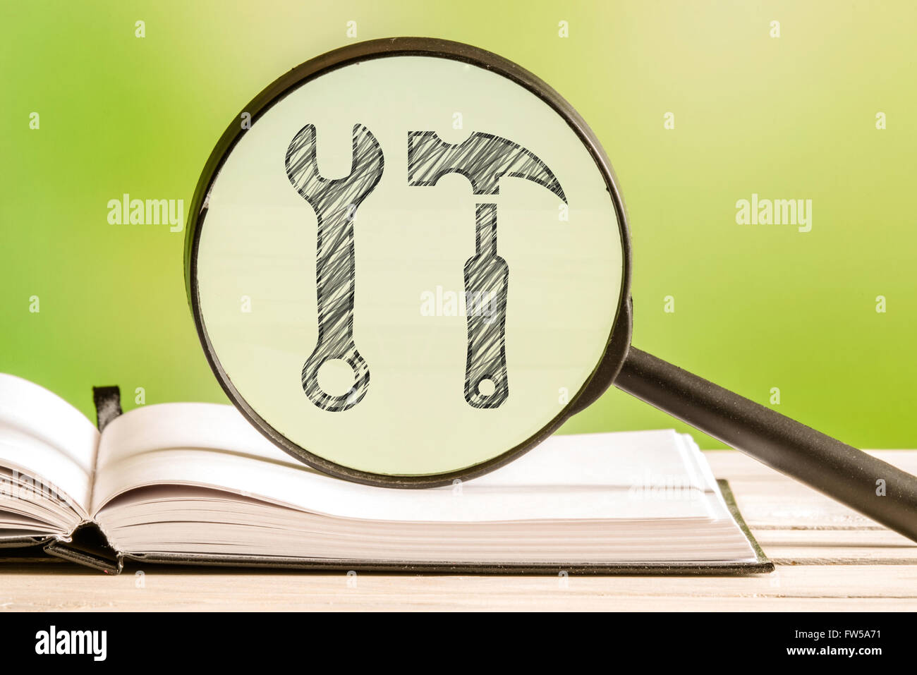 Preferences information with a pencil drawing of tools in a magnifying glass Stock Photo