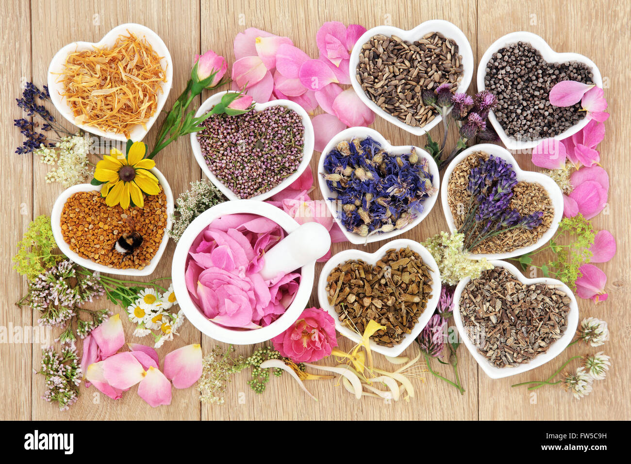 Flower and herb medicine selection used in alternative healing treatments in heart shaped