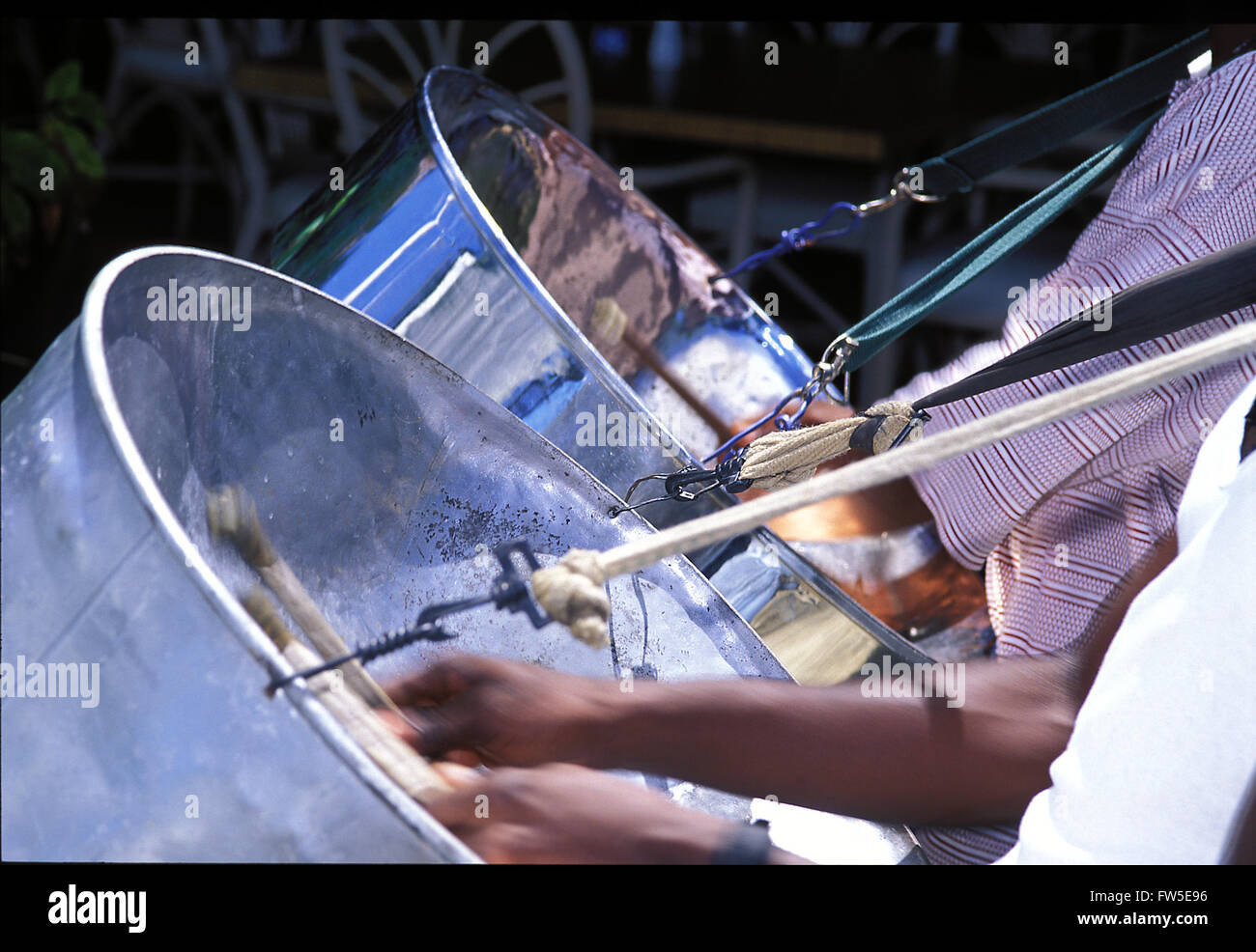 Steel pan / drum players using sticks on inside of Pans. Taken in