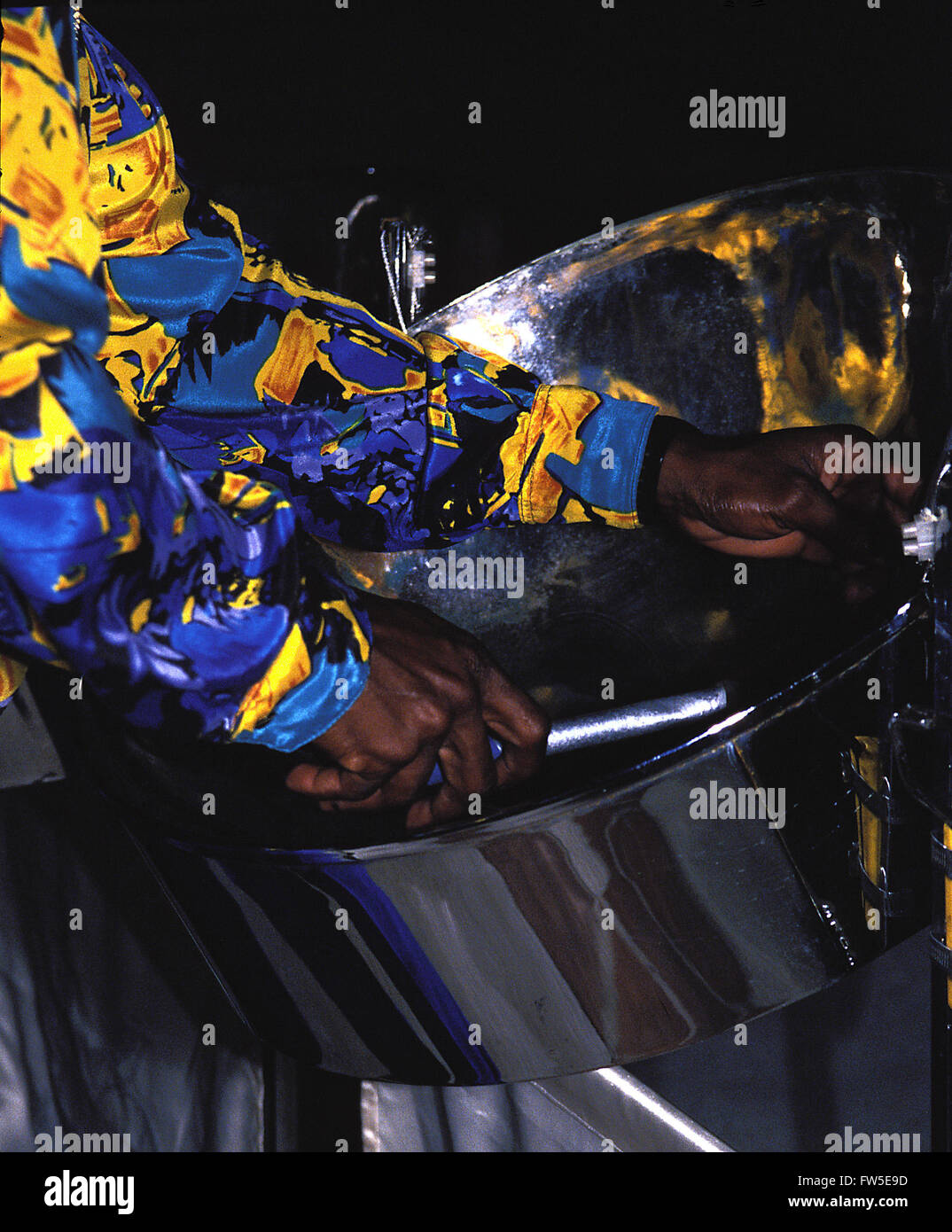Steel pans being played. Close up of pan and beater in steel pan band