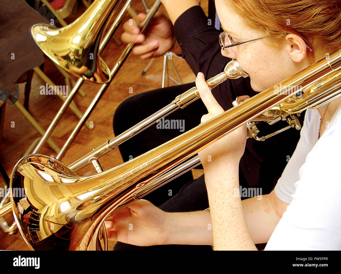 Trombone played by red headed girl in youth orchestra British