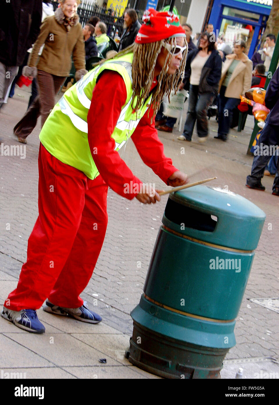 Busker in dreadlocks drumming on a rubbish bin Stock Photo - Alamy