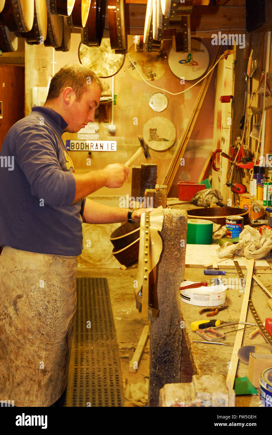Bodhran maker nailing 'head' to drum at the Roundstone Music