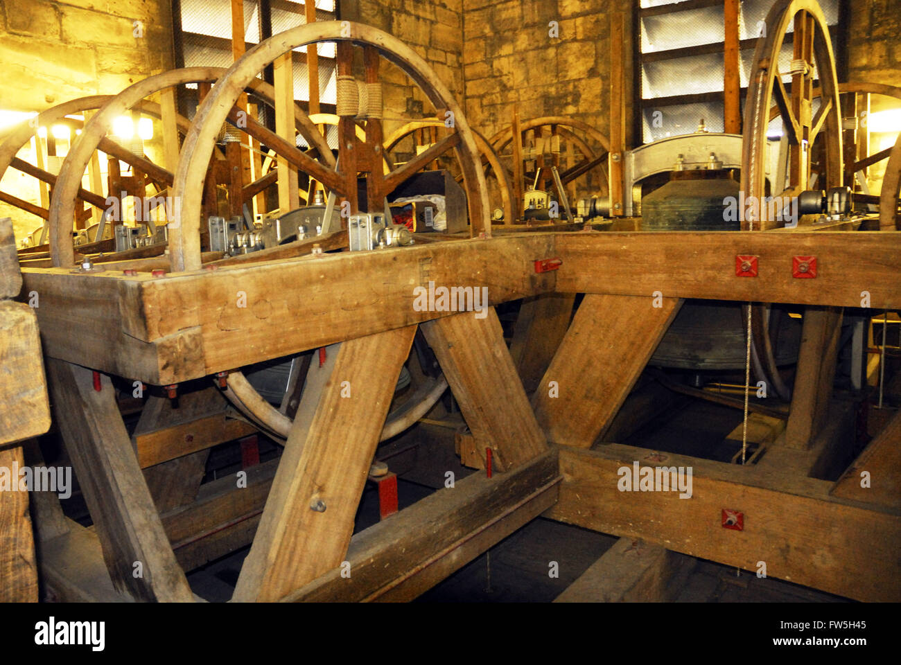 Old church bells, 1585 and 1625, in mechanism above south transept of Gloucester Cathedral, (Three Choirs Festival) Stock Photo