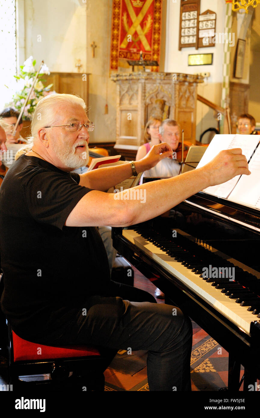 Jon Lord, composer, songwriter, keyboard player, organist, rehearsing the premiere of his flute concerto 'To Notice Such Things' at St Andrew's Church, Nuthurst, East Sussex, July 2009, as part of the Shipley Festival with flautist Bruce Martin. Dedicated to the late Sir John Mortimer. Jon Lord, born 1941, was previously the organist for Deep Purple and for Whitesnake, has pioneered a fusion of rock and classical forms, and developed a Hammond organ - Leslie blues-rock sound. Stock Photo