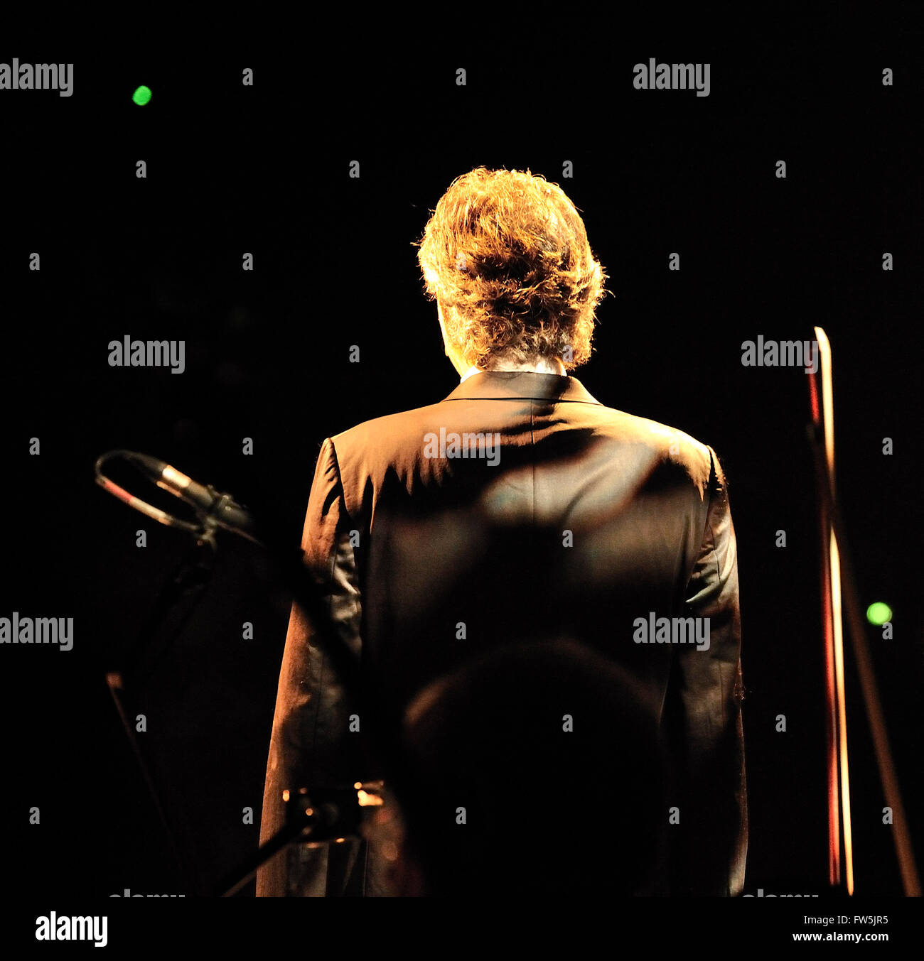 Andrea Bocelli, solo tenor, seen from behind, on stage on his 2009 UK national tour with the British Philharmonic Orchestra. Stock Photo