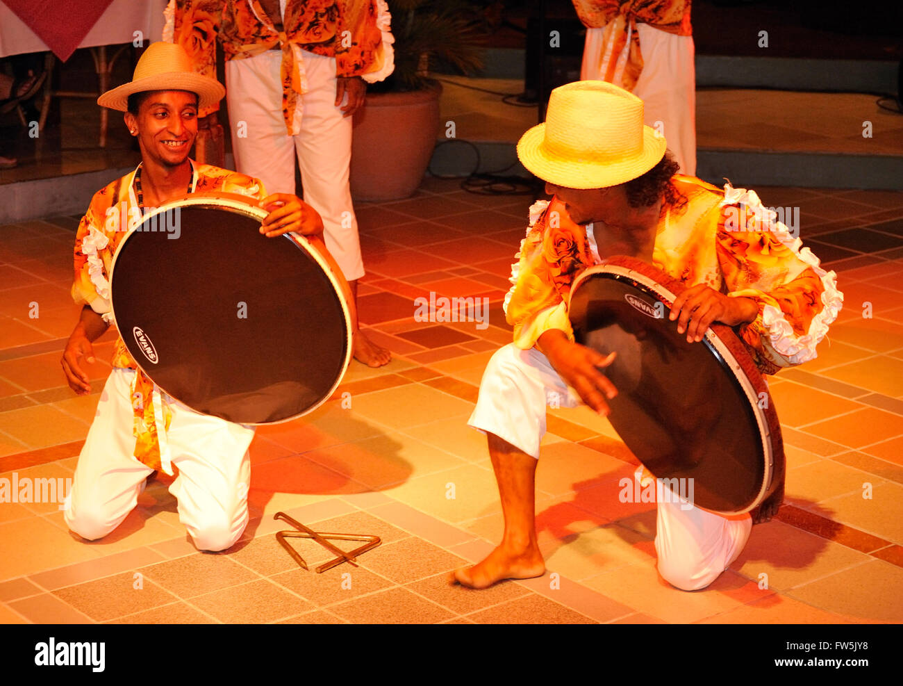 2 drummers playing Ravanne / ravane; single-headed large drum used in Sega, Mauritius, Indian Ocean. Sega is the national song Stock Photo