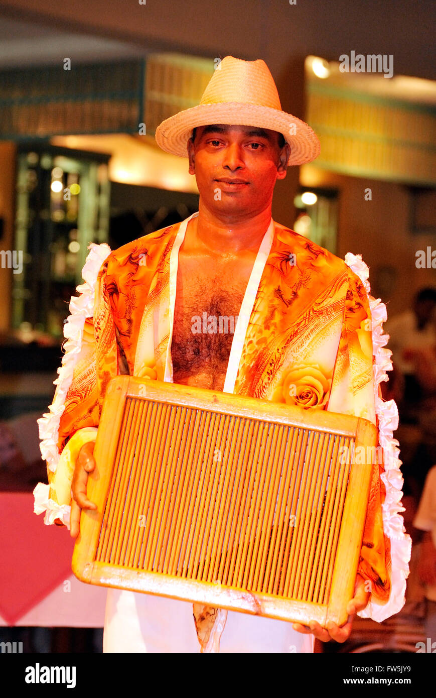 percussion musician showing maravanne / maravane, a rattle resembling a wash-board used in Sega, Mauritius, Indian Ocean. Sega Stock Photo