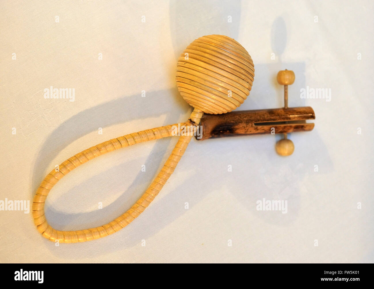 Mauritian folk rattle, maravanne, made of bamboo and raffia, in which balls slide back and forth between a tube. Mauritius. Can Stock Photo