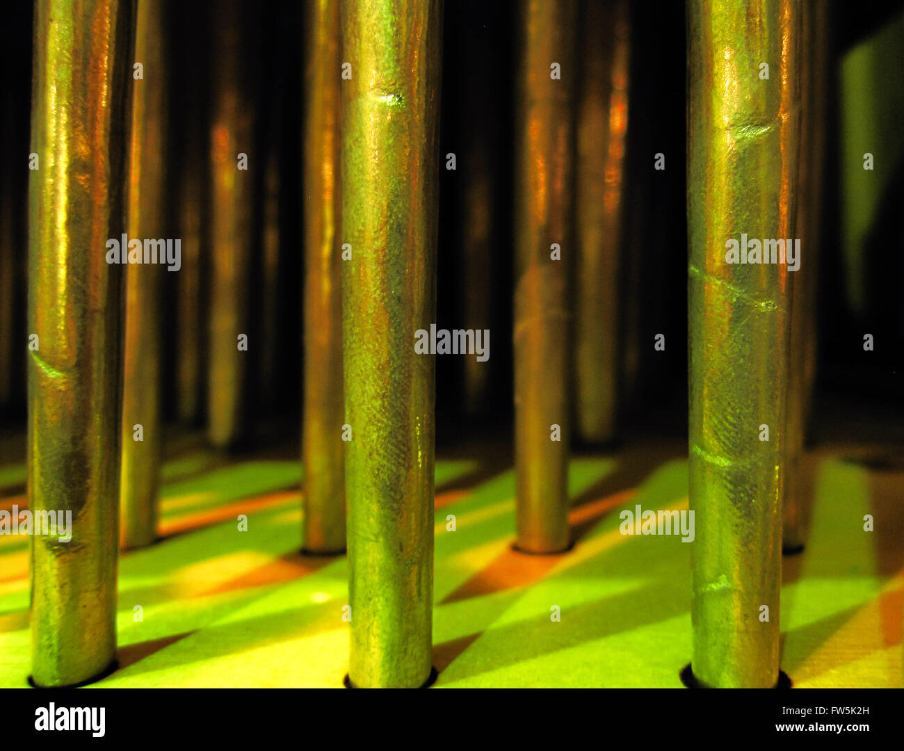 close-up of small metal organ pipes, in stage lighting, from inside a chamber organ by Peter Collins Ltd.; this type of concert platform organ is used especially for continuo playing in Baroque orchestras. Stock Photo