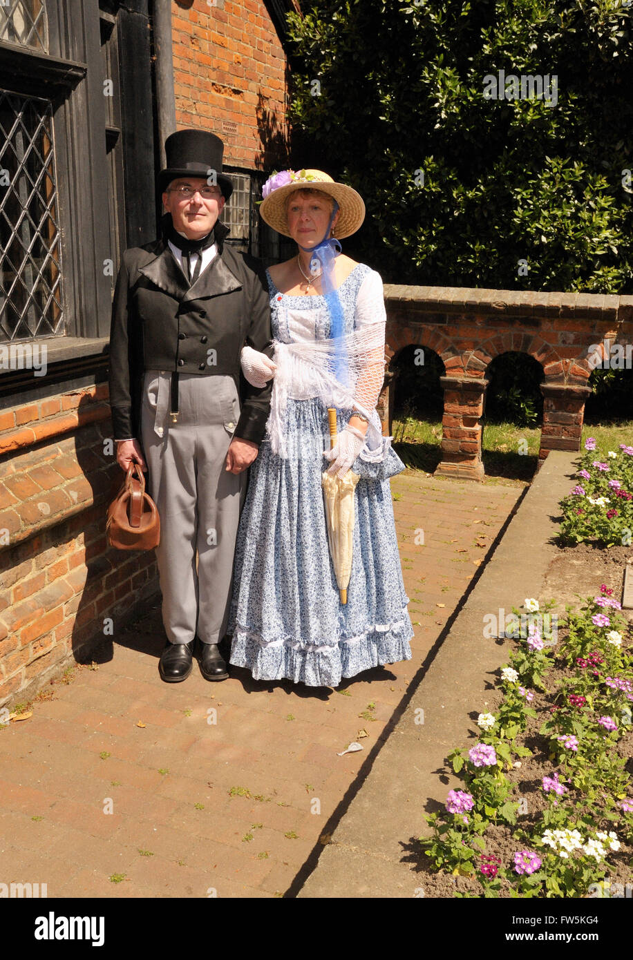 couple in Victorian costume outside, Eastgate House, Rochester High Street, Kent, the 'Nun's House' in the novel, 'Edwin Drood' Stock Photo