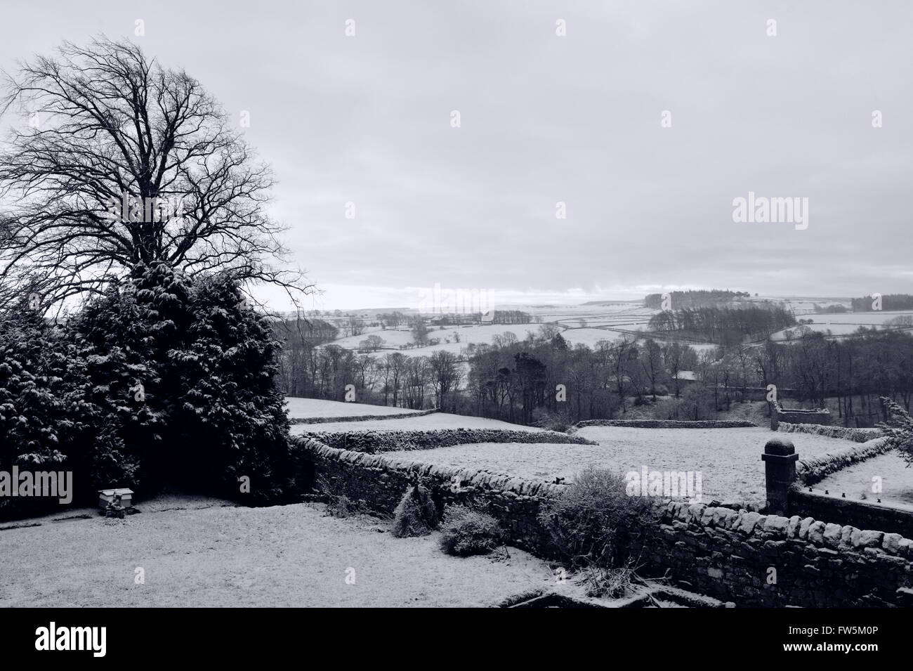 view of the Yorkshire Moors (now in Co. Durham), by the A66, under snow. From the graveyard in Bowes, where William Shaw, headmaster, is buried along with 8 pupils from his school, William Shaw's Academy, including George Ashton Tayor, the original of Smike, companion to Nicholas Nickleby in the novel by Charles Dickens, English author. William Shaw's Academy was one of several schools in the area offering tuition 'without holidays' to unwanted children, often from London. Dickens made a special visit through thick snow in February 1838, and denounced the cruelty and appalling conditions in hi Stock Photo