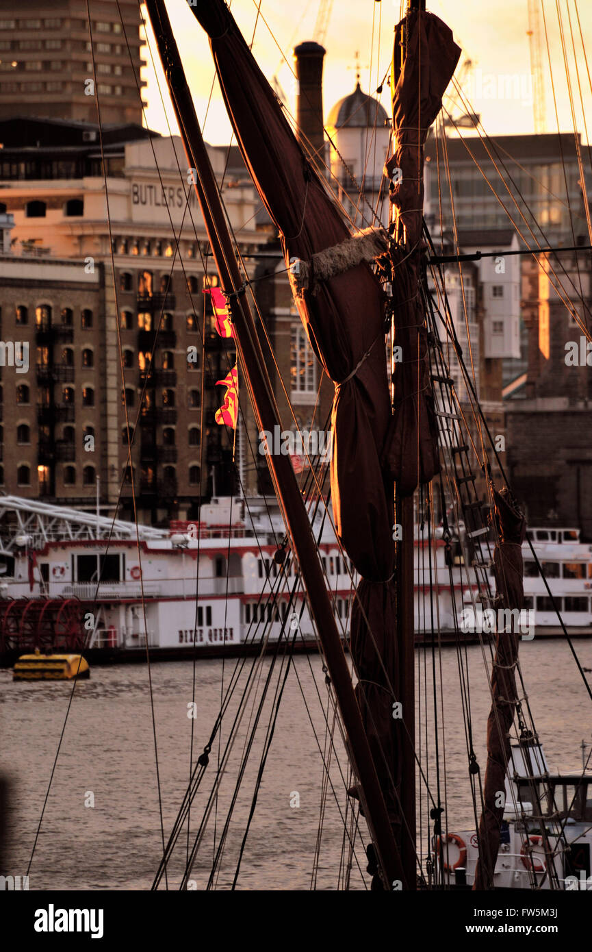 close-up: rigging of shipping: Thames barges, at St Katharine's Dock, by Wapping, London, by Tower Bridge at sunset, winter. Charles Dickens, English novelist, had a lifetime connection with Wapping and Limehouse, setting numerous scenes by the river, including Quilp's yard in The Old Curiosity Shop and Captain Cuttle's home in Dombey And Son. Stock Photo