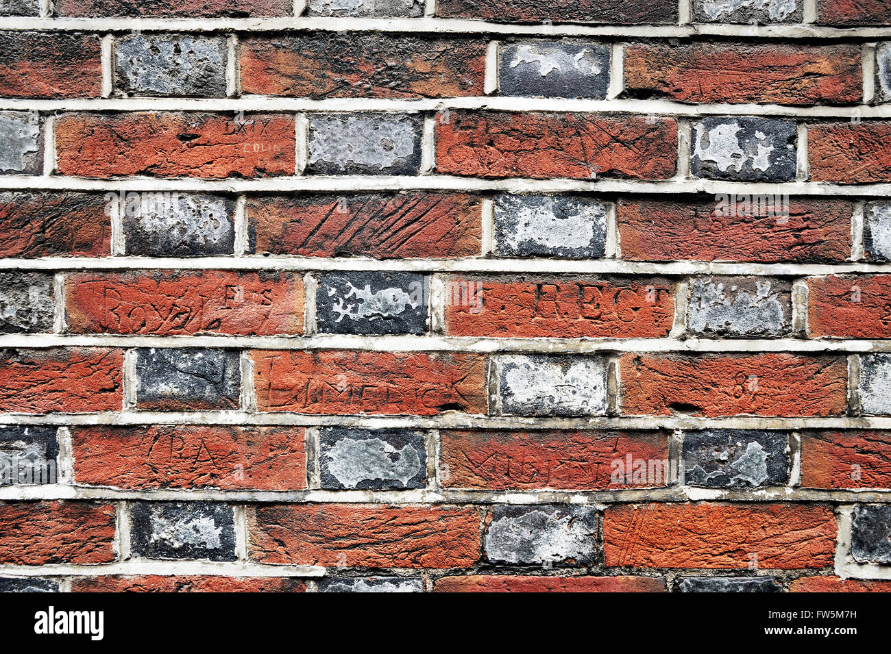 nineteenth century sailors' graffiti on the side wall of the Naval Pay Office in Portsmouth Historic Dockyard: John Dickens worked there in 1812, the father of novelist Charles Dickens. Stock Photo