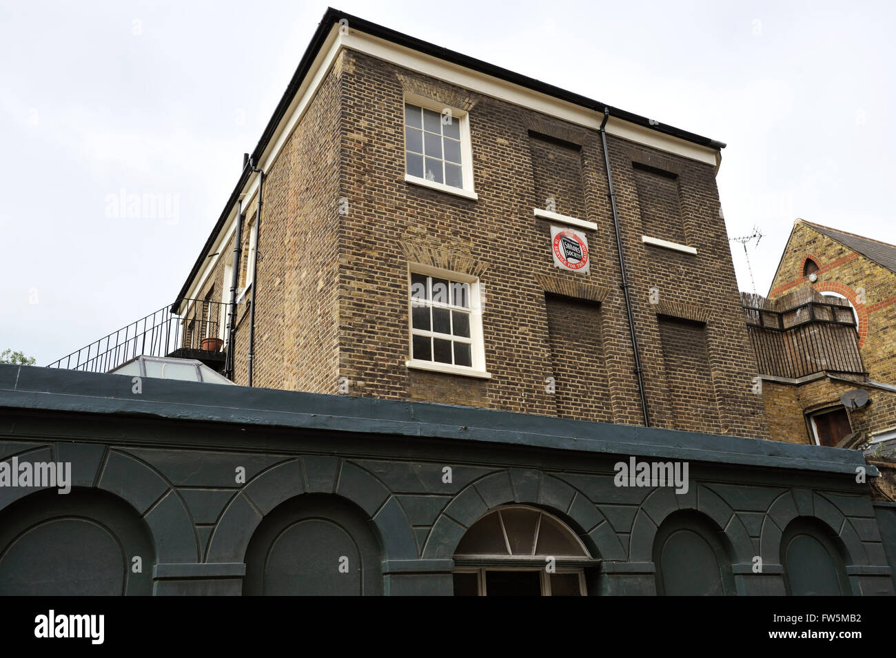 Victorian building of the Sailors' Society, Church Row, Limehouse. Charles Dickens would stay as a child with his godfather, the sail maker and chandler Christopher Huffam near the Hawksmoor church of St Anne across the road. The area features too in his writings: Dombey and Son, The Uncommercial Traveller and Our Mutual Friend. Stock Photo