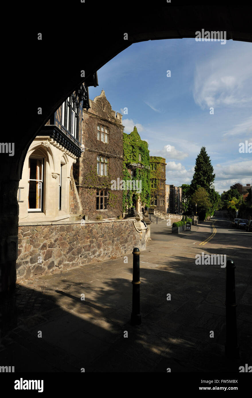 seen through the mediaeval Abbey Arch: The Abbey Hotel, Malvern, Worcestershire. Charles Dickens visited his sick wife Catherine many times around April 1851, who was taking the spa waters in Malvern. They stayed at Knotsford Lodge / 'Knutsford Lodge' he wrote on his letters, wrongly / Abbey Lodge. While she was here (only a week or so after the death of John Dickens, CD's father), Dickens had to inform her of the death in London of their infant daughter Dora. An ill-omened name, she had been named after the heroine of David Copperfield, who dies. Indeed just 5 days after the child had been bo Stock Photo