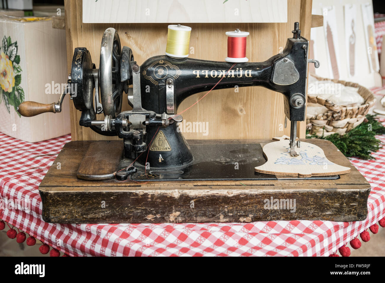 Trento, Italy - December 15, 2015: Old manual sewing machine used to embroider wooden shapes. Stock Photo