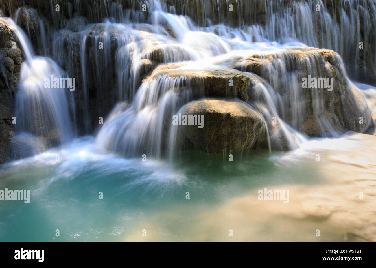 Green rushing water flowing over rocks Stock Photo