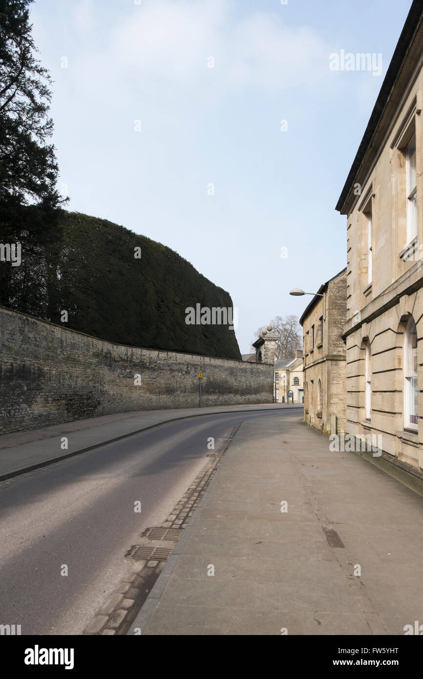 Park Lane on the one way system with the wall of the Bathurst Estate in Cirencester, Gloucestershire, UK Stock Photo