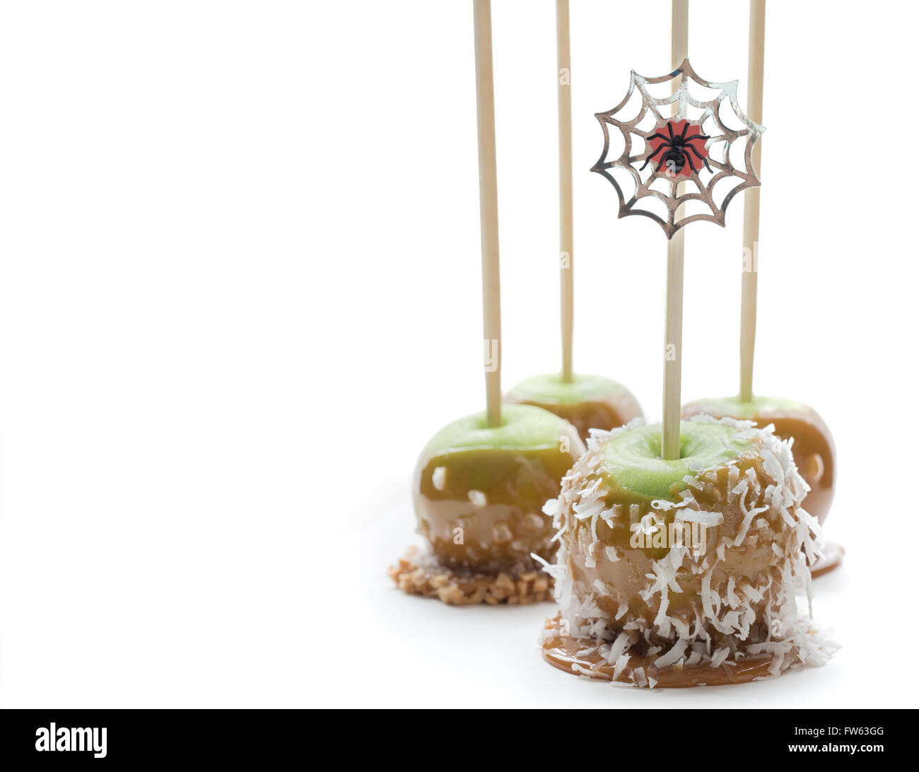 Four caramel apples for Halloween on a white background Stock Photo