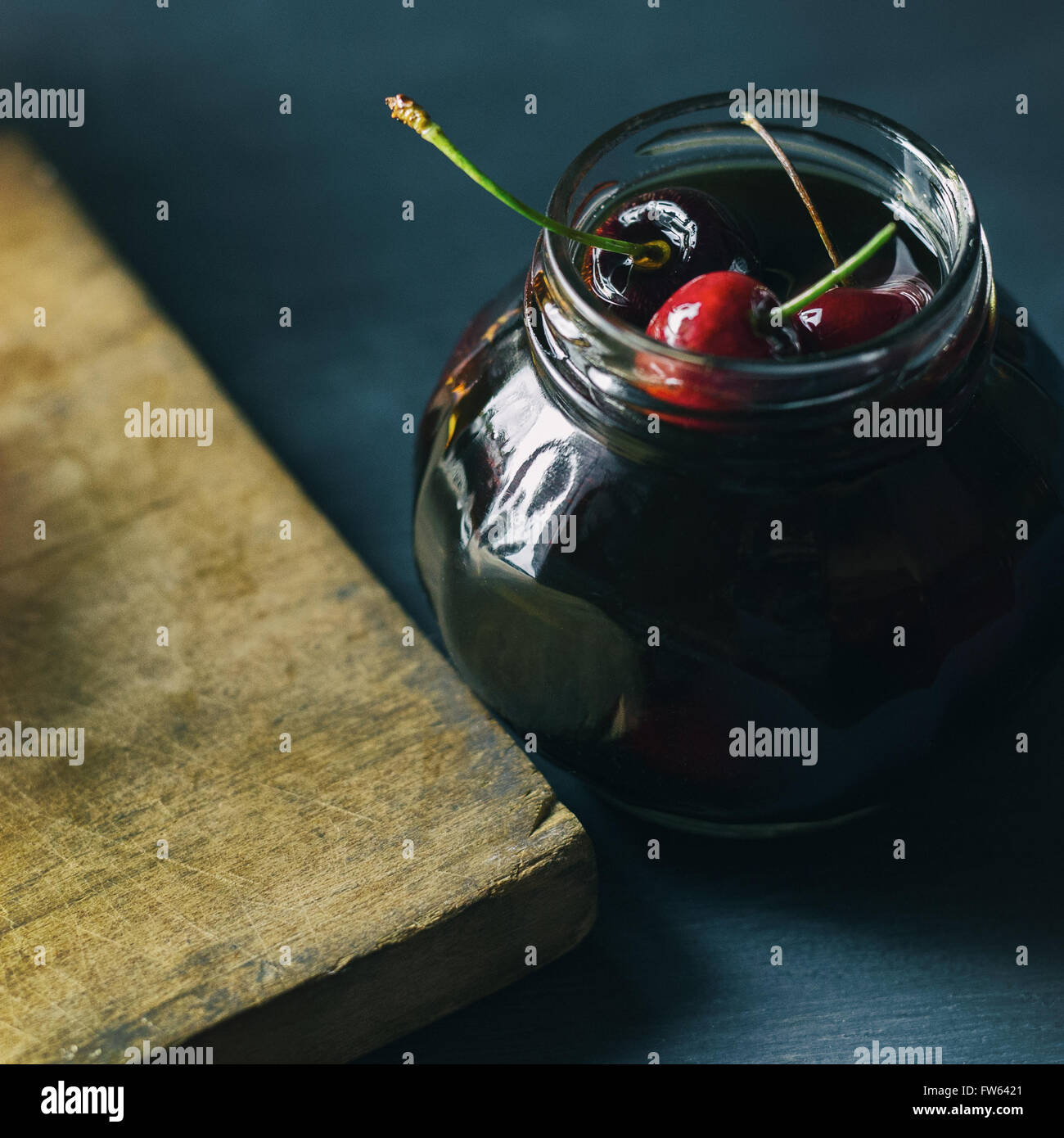 Fresh cherries in a jar filled with bourbon Stock Photo Alamy