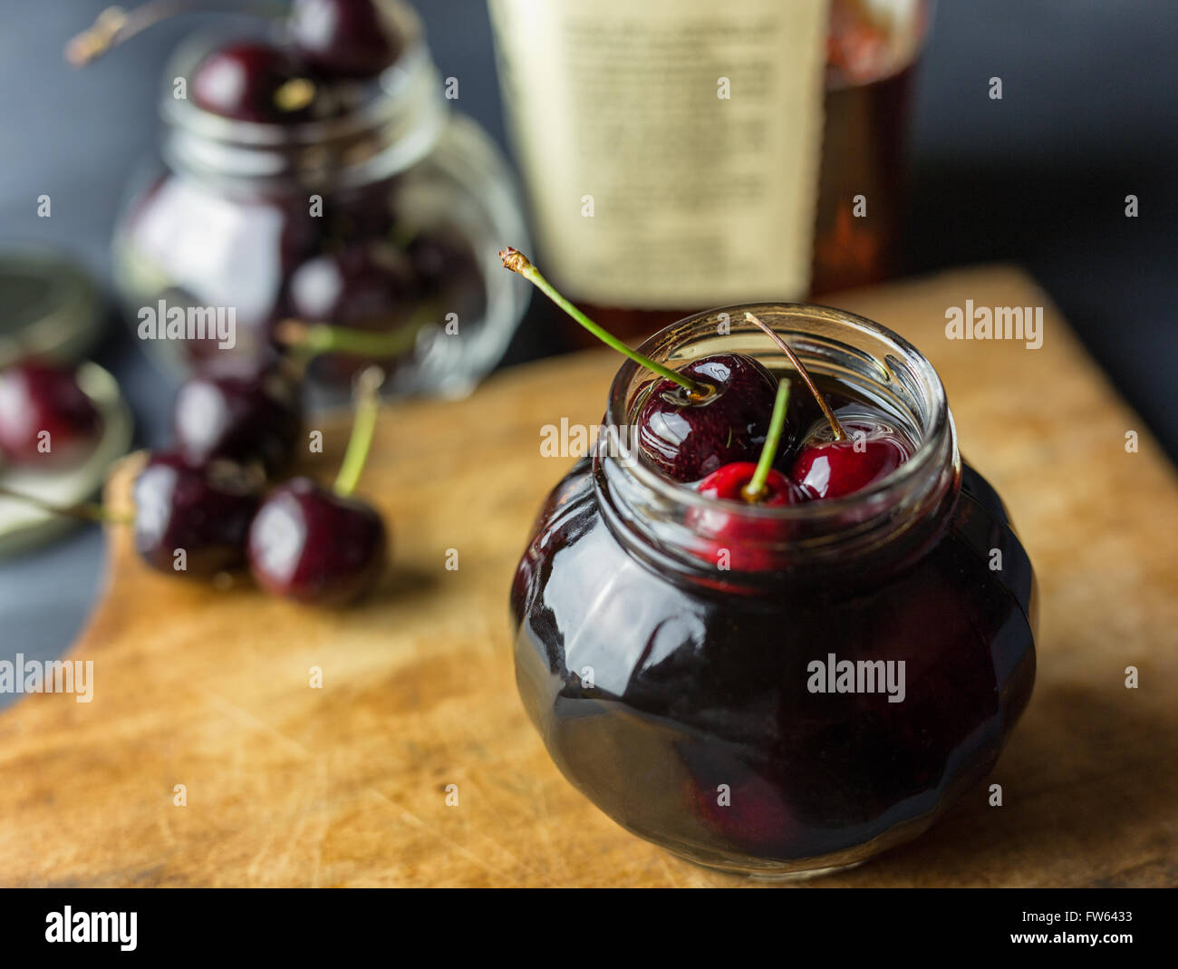Fresh cherries in a jar filled with bourbon Stock Photo Alamy