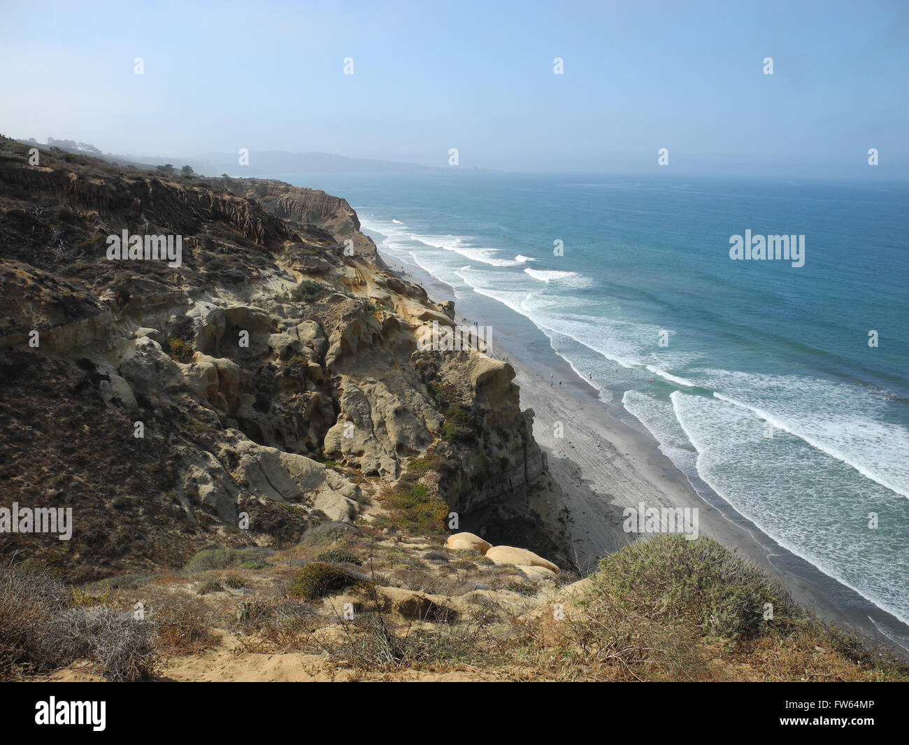 horizontal southern California coastline blue ocean waves shoreline rocky shore fog marine layer 