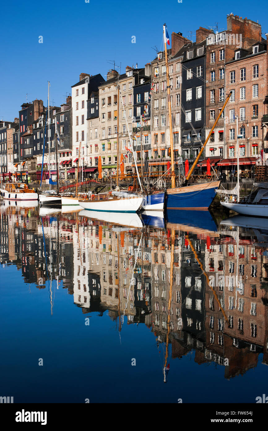 Houses and boats at the old harbor with reflections in calm water, Vieux Bassin, Honfleur, Calvados, Normandy, France Stock Photo