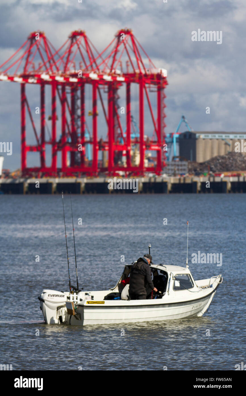 Boat Angler fishing with rod & line the tide at New Brighton on the River Mersey