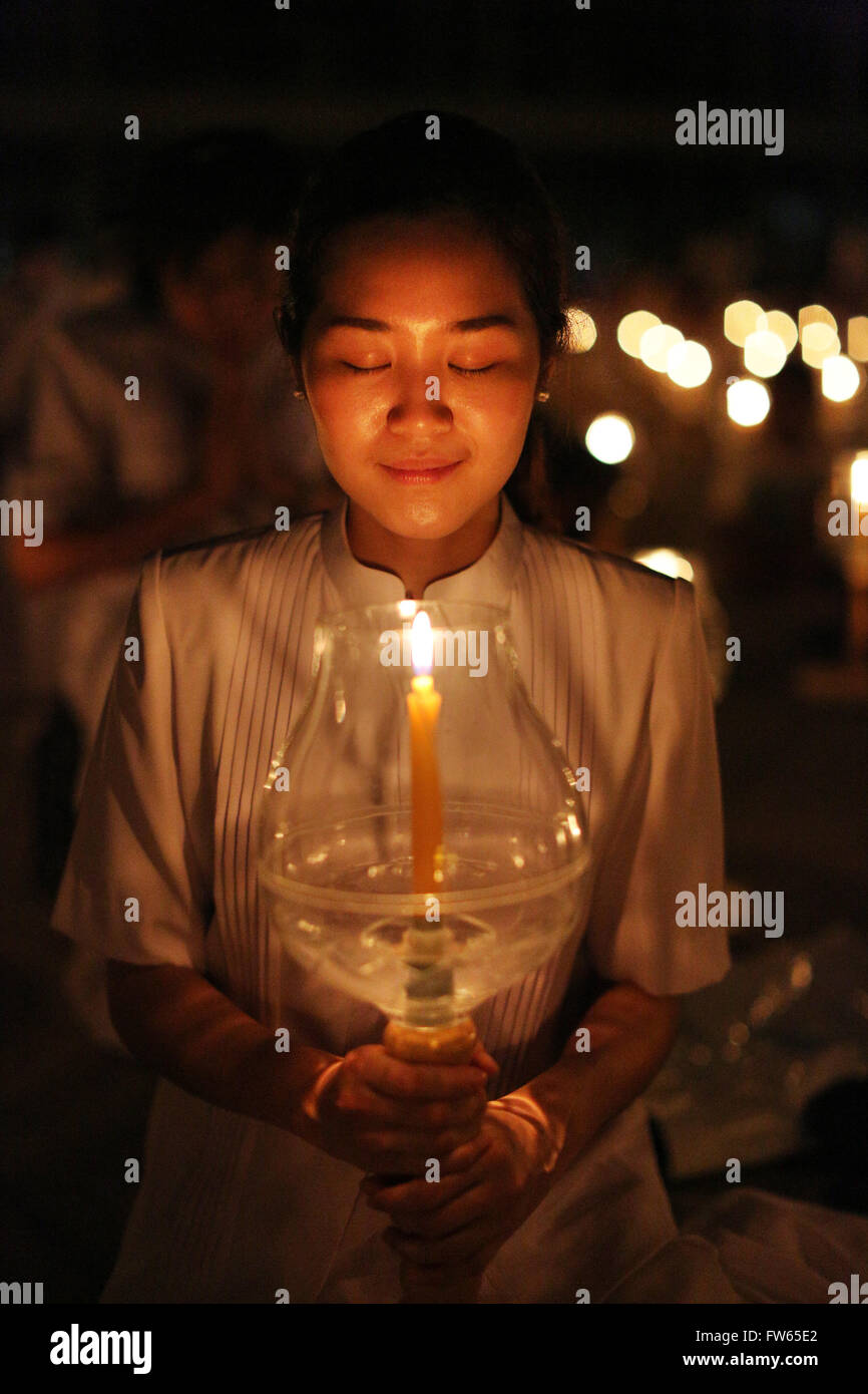 Young woman holding candle, festival of lights, candle in glass