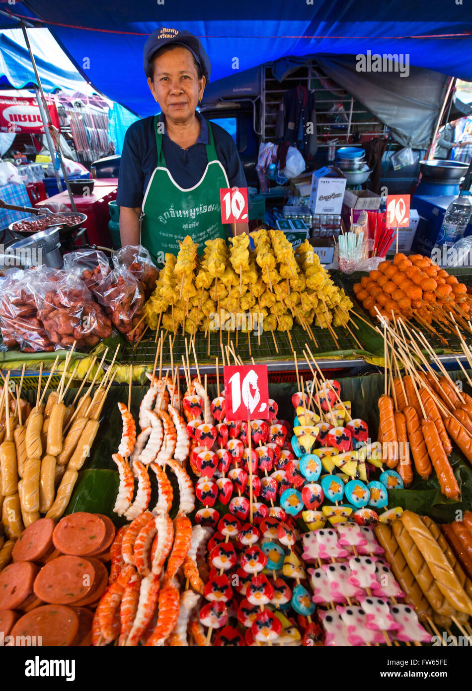 Market stall with various skewers with meat, fish and sausage, food stall, food for sale at a night market, Thailand Stock Photo